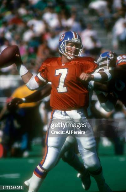 Quarterback John Elway of the Denver Broncos passes the ball in the game between the Denver Broncos vs the Philadelphia Eagles at Veterans Stadium on...