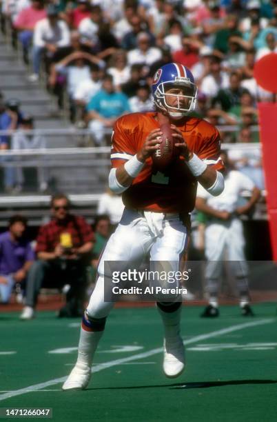Quarterback John Elway of the Denver Broncos drops back to pass in the game between the Denver Broncos vs the Philadelphia Eagles at Veterans Stadium...