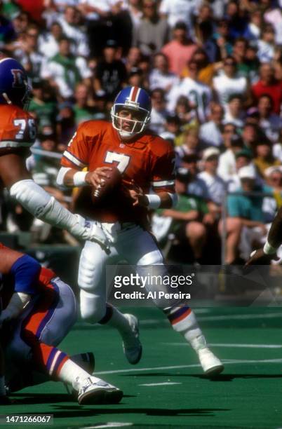 Quarterback John Elway of the Denver Broncos scrambles in the game between the Denver Broncos vs the Philadelphia Eagles at Veterans Stadium on...
