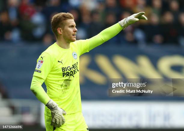 Ben Amos of Wigan Athletic points during the Sky Bet Championship between Wigan Athletic and Birmingham City at DW Stadium on March 04, 2023 in...