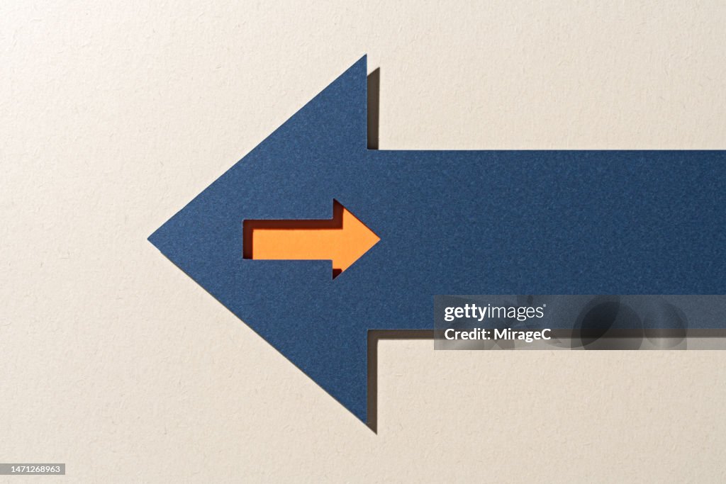 A Small Arrow Inside a Large Arrow Moving in the Reverse Direction