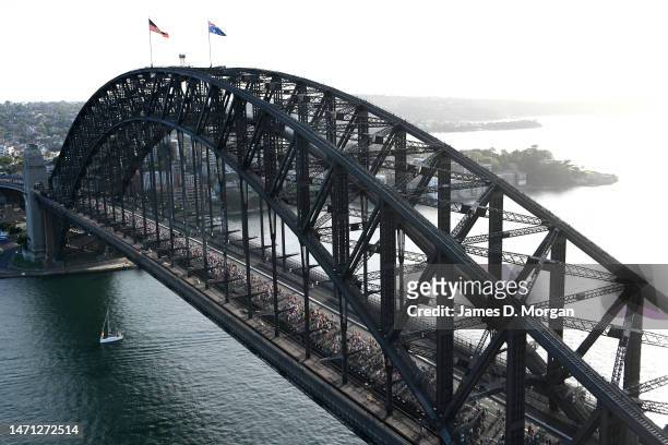 In this aerial view, people take part in Pride March over the Sydney Harbour Bridge on March 05, 2023 in Sydney, Australia. 50,000 people marched...
