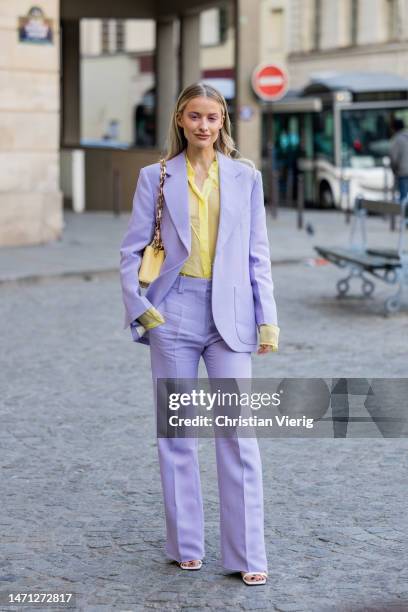 Victoria Magrath wears lavender suit, yellow blouse, bag outside Victoria Beckham during the Paris Fashion Week - Womenswear Fall Winter 2023 2024 :...