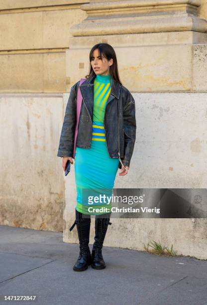 Nina Urgell Cloquell wears bomber jacket, turquoise green yellow dress, black boots outside Nina Ricci during the Paris Fashion Week - Womenswear...