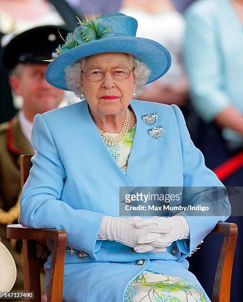 Queen Elizabeth II watches the Three Counties Diamond Jubilee River Pageant at Henley Business School during a visit to Henley-on-Thames as part of...