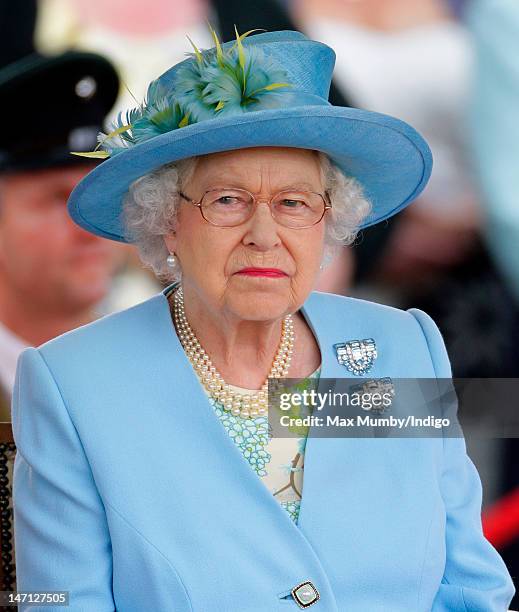 Queen Elizabeth II watches the Three Counties Diamond Jubilee River Pageant at Henley Business School during a visit to Henley-on-Thames as part of...