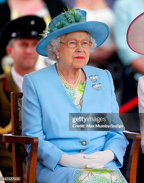 Queen Elizabeth II watches the Three Counties Diamond Jubilee River Pageant at Henley Business School during a visit to Henley-on-Thames as part of...