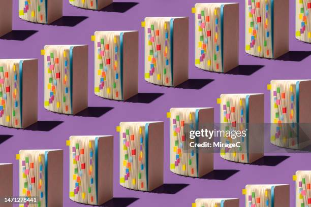 opened books with colorful bookmarks repetition pattern - group c foto e immagini stock