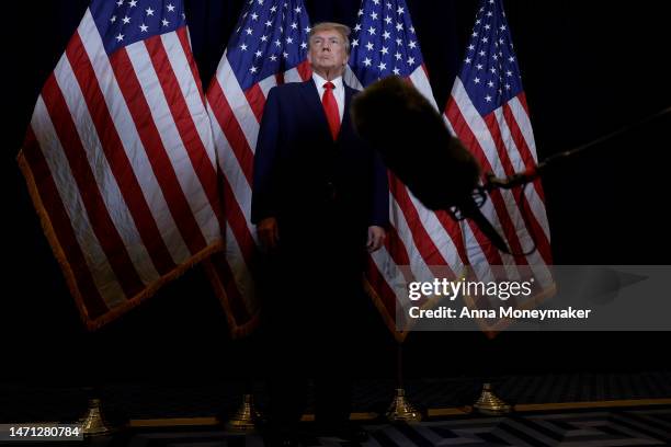 Former U.S. President Donald Trump speaks to reporters before his speech at the annual Conservative Political Action Conference at Gaylord National...