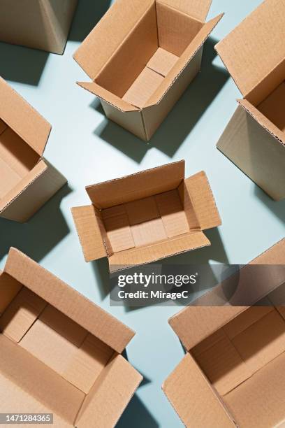 opened cardboard boxes on blue background - leere schachtel stock-fotos und bilder