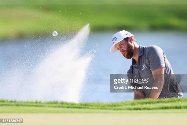 Chris Kirk of the United States plays a shot from a greenside bunker on the 17th hole during the third round of the Arnold Palmer Invitational...
