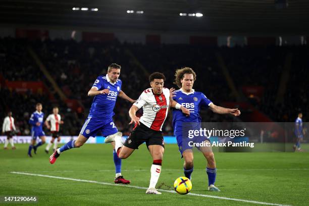 Che Adams of Southampton is tackled by Wout Faes of Leicester City during the Premier League match between Southampton FC and Leicester City at...