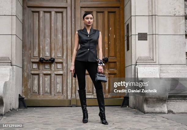 Kelsey Merritt is seen wearing a black Hermes sleeveless top, black pant and Hermes knee high boots with an Hermes scarf outside the Hermes show...