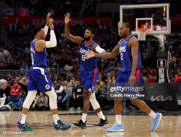 Russell Westbrook, Paul George and Kawhi Leonard of the LA Clippers celebrate a lead during a 108-101 Minnesota Timberwolves win at Crypto.com Arena...