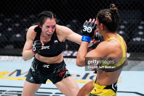 Jessica Penne punches Tabatha Ricci of Brazil in a strawweight fight during the UFC 285 event at T-Mobile Arena on March 04, 2023 in Las Vegas,...