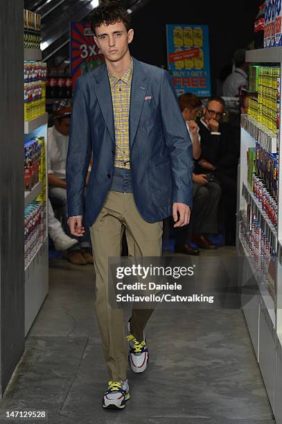 Model walks the runway at the Moschino Spring Summer 2013 fashion show during Milan Menswear Fashion Week on June 25, 2012 in Milan, Italy.