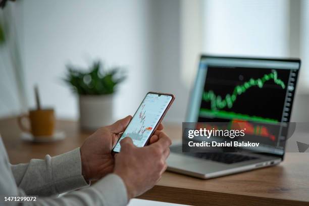 day trading stocks. trader studying stock markets on tradingview app. - stock market trading stock pictures, royalty-free photos & images