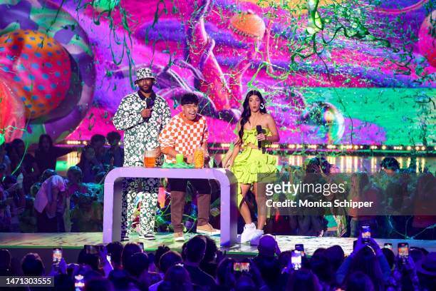 Nate Burleson, SeanDoesMagic, and Charli D'Amelio speak onstage during the 2023 Nickelodeon Kids' Choice Awards at Microsoft Theater on March 04,...