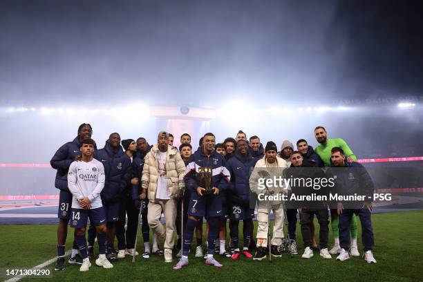 Kylian Mbappe of Paris Saint-Germain poses with teammates after becoming the PSG top scorer with 201 goals after the Ligue 1 match between Paris...