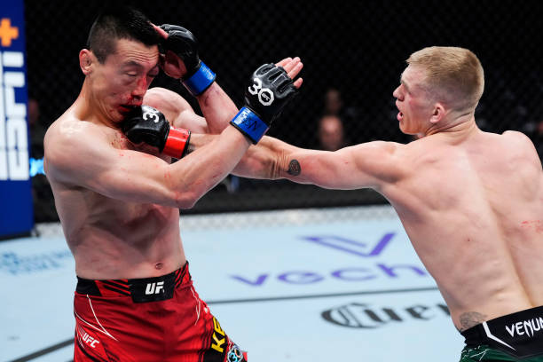 Ian Garry of Ireland punches Song Kenan of China in a welterweight fight during the UFC 285 event at T-Mobile Arena on March 04, 2023 in Las Vegas,...