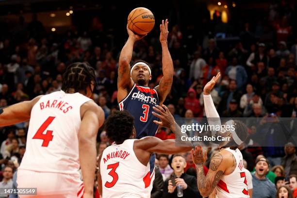 Bradley Beal of the Washington Wizards puts up a shot in front of Scottie Barnes, O.G. Anunoby and Gary Trent Jr. #33 of the Toronto Raptors in the...