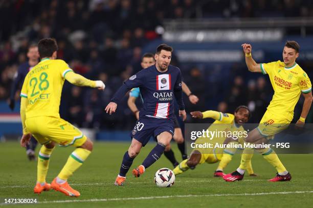 Leo Messi of Paris Saint-Germain fights for possession during the Ligue 1 match between Paris Saint-Germain and FC Nantes at Parc des Princes on...