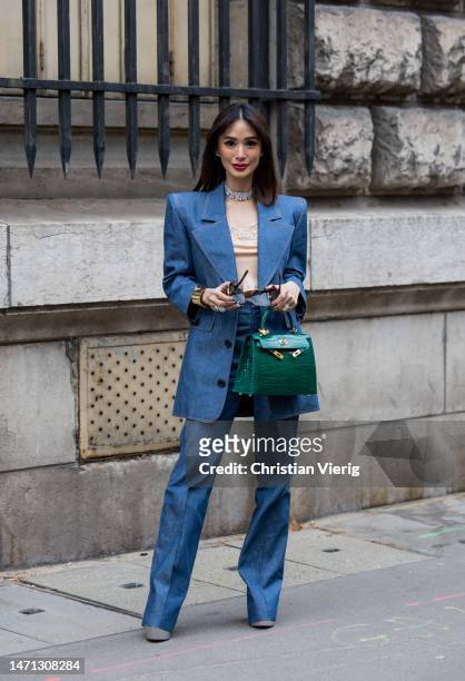 Heart Evangelista wears blue tailored strong shoulder line blazer, flared pants, green bag outside Hermes during Paris Fashion Week - Womenswear Fall...