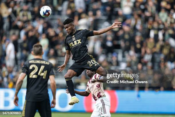 José Cifuentes of the Los Angeles FC jumps above Diego Chara of the Portland Timbers at midfield for a volley during a game between the Portland...