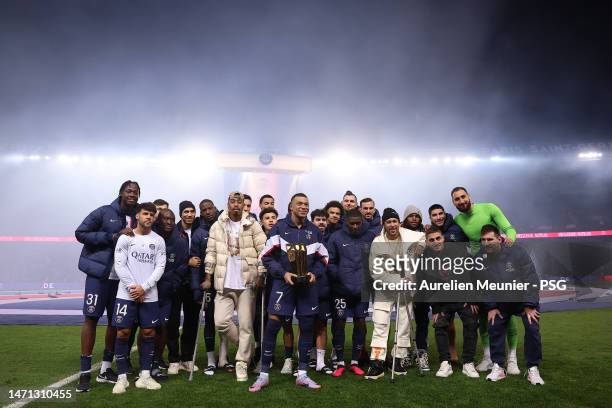 Kylian Mbappe of Paris Saint-Germain poses with teammates after becoming the PSG top scorer with 201 goals after the Ligue 1 match between Paris...