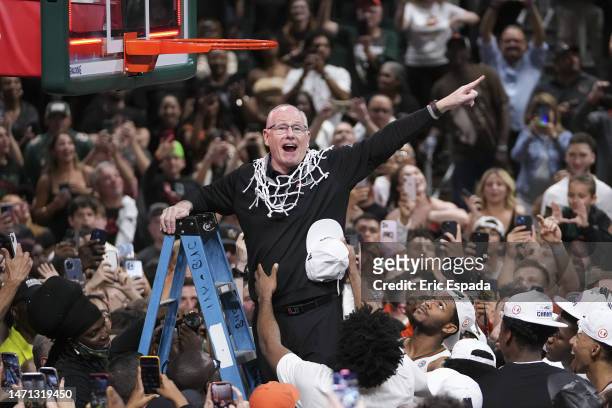 Head Coach Jim Larrañaga of the Miami Hurricanes cuts down the net after defeating the Pittsburgh Panthers 78-76 to win a share of the ACC...