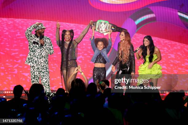 Nate Burleson, Bianca Belair, Ariel Sherwood, Becky Lynch, and Charli D'Amelio speak onstage during the 2023 Nickelodeon Kids' Choice Awards at...