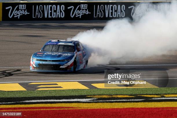 Austin Hill, driver of the Global Industrial Chevrolet, celebrates with a burnout after winning the NASCAR Xfinity Series Alsco Uniforms 300 at Las...