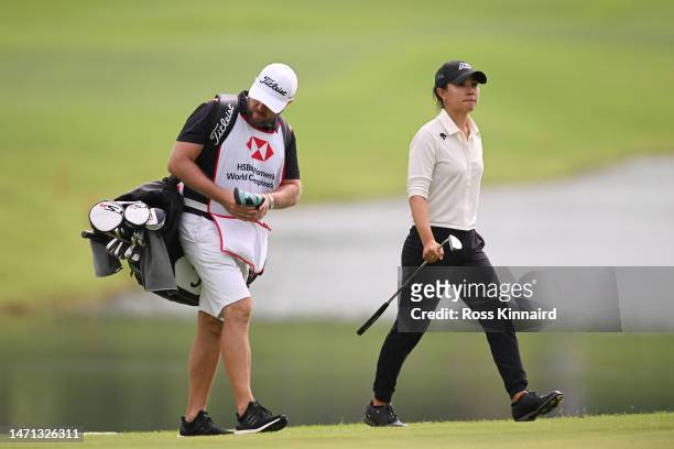 Danielle Kang of The United States and her caddie walk on the fifth hole during Day Four of the HSBC Women's World Championship at Sentosa Golf Club...