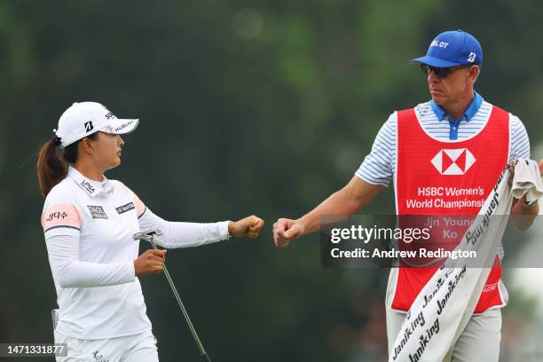 Jin Young Ko of South Korea fist bumps her caddie on the fifth green during Day Four of the HSBC Women's World Championship at Sentosa Golf Club on...