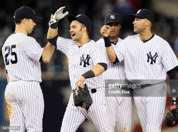 Nick Swisher celebrates the win with Mark Teixeira, Robinson Cano and Derek Jeter of the New York Yankees after the win over the Cleveland Indians on...