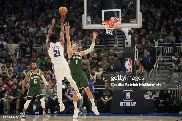 Joel Embiid of the Philadelphia 76ers shoots the ball against Brook Lopez of the Milwaukee Bucks in the first half of the game at Fiserv Forum on...