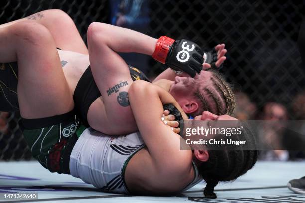 Alexa Grasso of Mexico secures a rear choke submission against Valentina Shevchenko of Kyrgyzstan in the UFC flyweight championship fight during the...