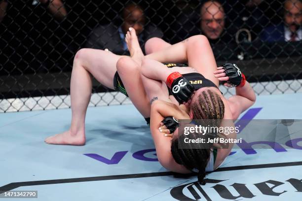 Alexa Grasso of Mexico secures a rear choke submission against Valentina Shevchenko of Kyrgyzstan in the UFC flyweight championship fight during the...