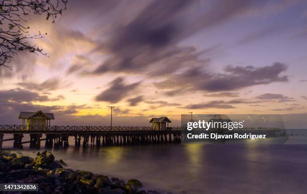 sunset in front of the tourist pier in the city of la ceiba, honduras. - la ceiba stock pictures, royalty-free photos & images