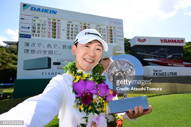 Jiyai Shin of South Korea imitates a selfie after winning the tournament following the final round of Daikin Orchid Ladies at Ryukyu Golf Club on...