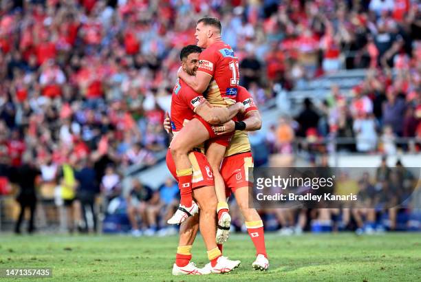 Jesse Bromwich, Tom Gilbert and Brenko Lee of the Dolphins celebrate the Dolphins first ever victory in the NRL after the round one NRL match between...