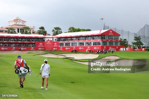 Jin Young Ko of South Korea and her caddie walk on the eighteenth hole during Day Four of the HSBC Women's World Championship at Sentosa Golf Club on...