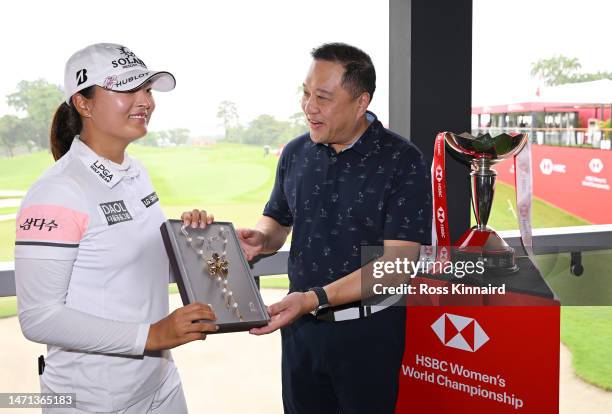 Jin Young Ko of South Korea is presented with a necklace by Wong Kee Joo, CEO of HSBC Singapore after winning during Day Four of the HSBC Women's...