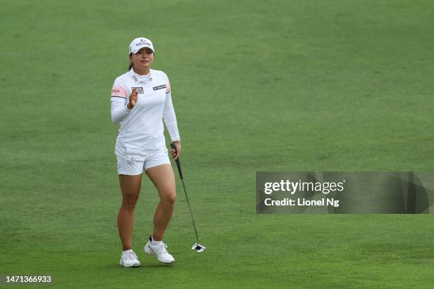 Jin Young Ko of South Korea acknowledges the crowd as she walks to the eighteenth green during Day Four of the HSBC Women's World Championship at...