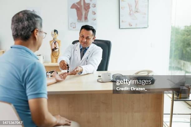 senior chinese patient visiting doctor - nutritionist having consultations with senior patient and performing blood sugar test - doctor general practitioner stock pictures, royalty-free photos & images