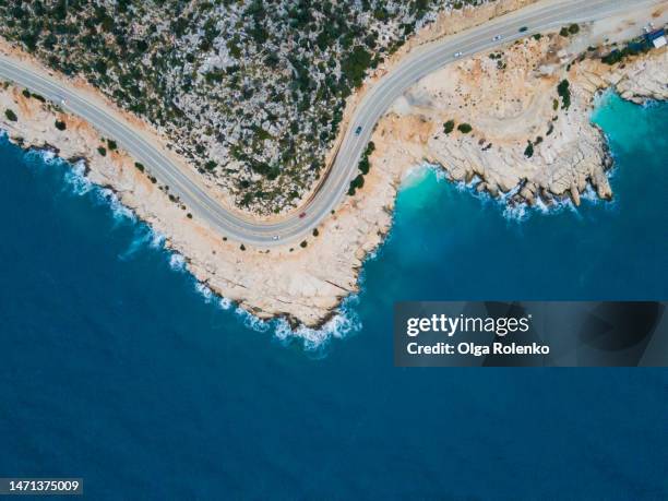 aerial view of peninsula mountain road and cars on the seaside. - peninsula stock pictures, royalty-free photos & images