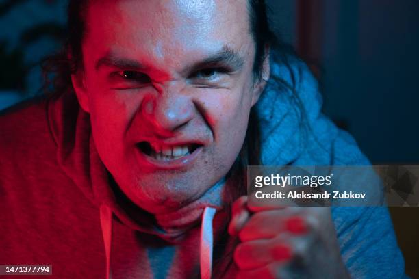 angry, indignant, angry young man or crazy, in casual clothes. the concept of the wrong way of life of people, aggression. a nervous student, a drunk person shows aggression. portrait of a crazy, unshaven angry teenager looking into the camera. - roommates arguing stock pictures, royalty-free photos & images