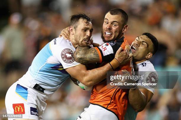 David Klemmer of the Wests Tigers is tackled during the round one NRL match between the Wests Tigers and the Gold Coast Titans at Leichhardt Oval on...