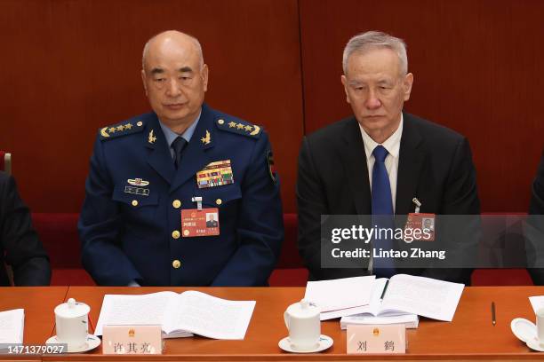 Vice Chairman of China's Central Military Commission Xu Qiliang and China's Vice Premier Liu He attend the opening of the first session of the 14th...