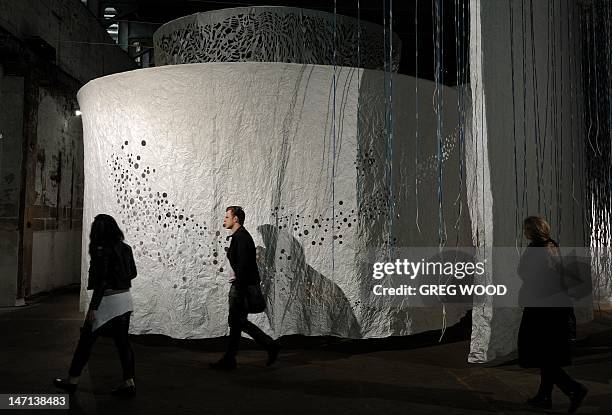 Members of the media inspect an installation titled 'Source', by artists Tanya Tagaq from Canada and Ed Pien from Taiwan, on Cockatoo Island near...